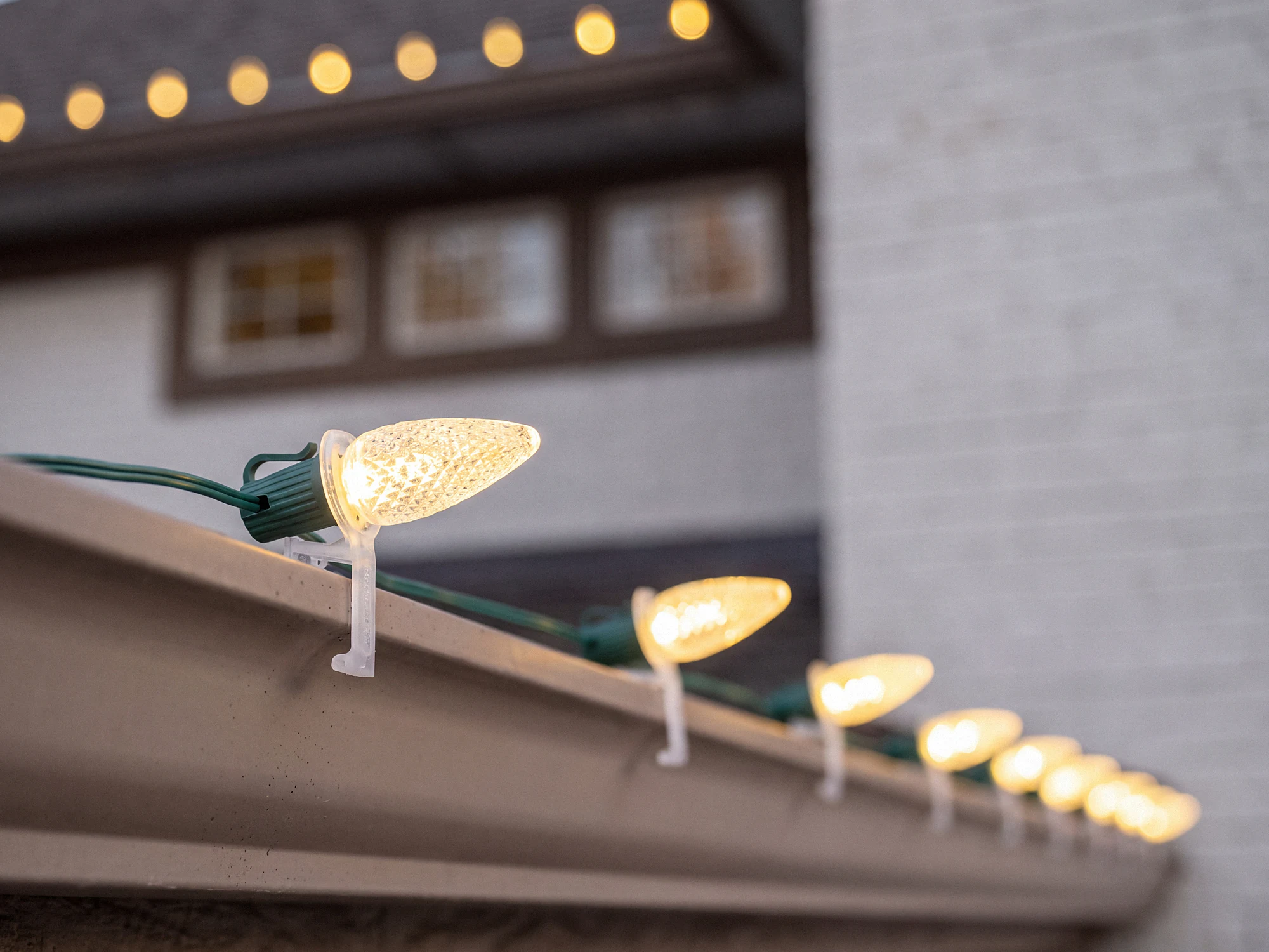 Close-up of custom-cut C9 bulbs on a roofline